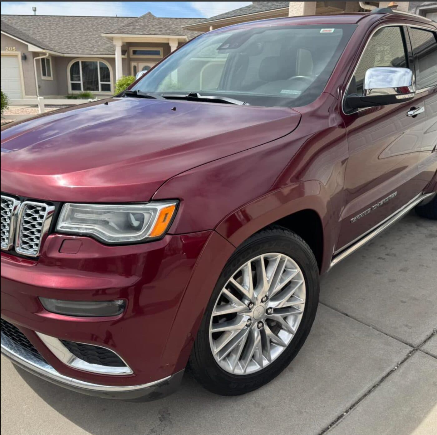 Maroon Jeep Grand Cherokee gleaming after wash