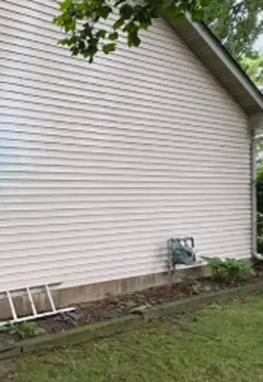 Clean beige vinyl siding on the side of a house